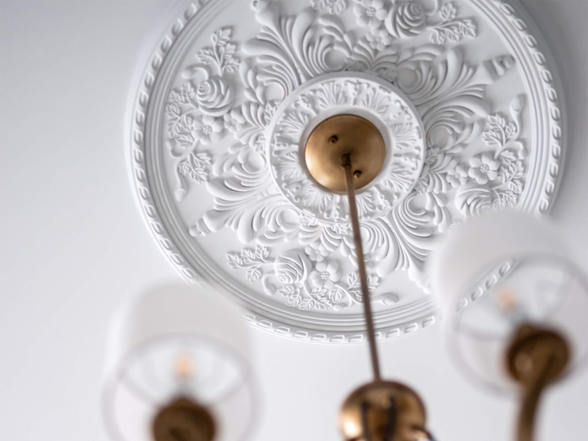 Close up of Thisbe chandelier with ornate ceiling medallion. 